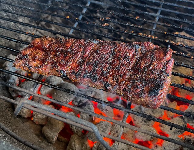 Grilling a steak on charcoal hotsell